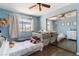 Bright bedroom featuring hardwood floors, neutral paint, a ceiling fan, and a large mirror closet at 7553 Durham Hall Ave # 201, Las Vegas, NV 89130