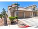 Inviting two-story home featuring a two-car garage, tiled roof, and neat landscaping for great curb appeal at 7553 Durham Hall Ave # 201, Las Vegas, NV 89130
