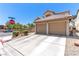 Attached two-car garage featuring a concrete driveway and desert landscaping at 7553 Durham Hall Ave # 201, Las Vegas, NV 89130