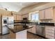 Well-appointed kitchen with stainless steel appliances, dark granite countertops, and ample cabinet space at 7553 Durham Hall Ave # 201, Las Vegas, NV 89130