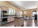 Open kitchen featuring stainless steel appliances, dark countertops, wood floors, and an eat-in island at 7553 Durham Hall Ave # 201, Las Vegas, NV 89130