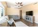 Comfortable living room featuring a large sectional sofa, ceiling fan, and modern flooring at 7553 Durham Hall Ave # 201, Las Vegas, NV 89130