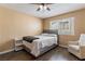 Cozy bedroom features hardwood floors, a ceiling fan, natural light, and neutral paint at 7553 Durham Hall Ave # 201, Las Vegas, NV 89130