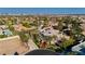 Expansive aerial view showcasing the property with a well-manicured lawn and palm trees at 7625 Coley Ave, Las Vegas, NV 89117