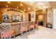 Elegant home bar featuring custom cabinetry, granite countertop, and decorative lighting at 7625 Coley Ave, Las Vegas, NV 89117