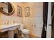 Charming half-bathroom featuring a marble sink, toilet, and decorative wall tiles at 7625 Coley Ave, Las Vegas, NV 89117