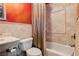 Cozy bathroom with tiled walls, a bathtub with shower, and functional fixtures at 7625 Coley Ave, Las Vegas, NV 89117