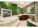 Luxurious bathroom features a soaking tub and unique greenery wall at 7625 Coley Ave, Las Vegas, NV 89117