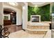 Luxurious bathroom with a tiled step-up bathtub, a green garden wall, and a view into the walk-in closet at 7625 Coley Ave, Las Vegas, NV 89117