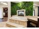 Lavish bathroom with soaking tub and a fireplace nestled in a green wall at 7625 Coley Ave, Las Vegas, NV 89117