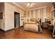 Cozy bedroom with hardwood floors, patterned wallpaper, and warm lighting creating a relaxing ambiance at 7625 Coley Ave, Las Vegas, NV 89117