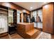 Large walk-in closet with custom wood cabinets, drawers, shelves, and island for storing clothing at 7625 Coley Ave, Las Vegas, NV 89117