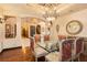 Formal dining room featuring glass table, ornate chairs, decorative ceiling, and hardwood floors at 7625 Coley Ave, Las Vegas, NV 89117