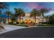 Stately home at dusk with manicured lawn, towering palm trees, and warmly lit exterior; perfect for evening gatherings at 7625 Coley Ave, Las Vegas, NV 89117