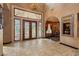 Elegant foyer with travertine flooring, ornate ironwork, and exquisite lighting, offering a grand welcome at 7625 Coley Ave, Las Vegas, NV 89117