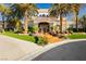 Inviting entrance with lush lawn, vibrant flower pots, and an elegant doorway featuring wrought iron detailing at 7625 Coley Ave, Las Vegas, NV 89117