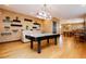 Spacious game room with wood floors, decorative shelving, and an air hockey table at 7625 Coley Ave, Las Vegas, NV 89117