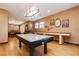 Bright game room with air hockey table, pool table, and unique vintage lighting at 7625 Coley Ave, Las Vegas, NV 89117