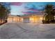 Spacious three-car garages providing ample parking, complemented by classic carriage lights and well-maintained landscaping at 7625 Coley Ave, Las Vegas, NV 89117