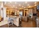 Elegant kitchen featuring custom cabinetry, granite countertops, and a breakfast bar with seating at 7625 Coley Ave, Las Vegas, NV 89117