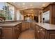Kitchen with stone countertops, wood cabinets, tiled floors, with decorative chandelier at 7625 Coley Ave, Las Vegas, NV 89117