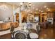 Gourmet kitchen and dining area with designer chandelier, dark wood cabinets, and stainless steel appliances at 7625 Coley Ave, Las Vegas, NV 89117