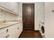 Spacious laundry room featuring white cabinetry and granite countertops at 7625 Coley Ave, Las Vegas, NV 89117