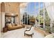 Bright and airy living room with high ceilings, floor-to-ceiling windows, fireplace, and natural light overlooking landscaped backyard at 7625 Coley Ave, Las Vegas, NV 89117