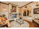 Elegant living room with fireplace, textured walls, hardwood floors, and ornate decor for a luxurious feel at 7625 Coley Ave, Las Vegas, NV 89117