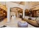 Open-concept living space featuring elegant columns, travertine floors, designer lighting, and high-end furnishings at 7625 Coley Ave, Las Vegas, NV 89117