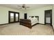Spacious main bedroom featuring a large bed, ceiling fan, and access to a private balcony at 7625 Coley Ave, Las Vegas, NV 89117