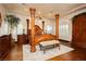 Luxurious main bedroom featuring a four-poster bed, hardwood floors, and natural light at 7625 Coley Ave, Las Vegas, NV 89117