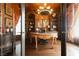 Luxury office featuring custom built-ins, unique chandelier, and hardwood flooring at 7625 Coley Ave, Las Vegas, NV 89117