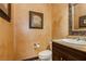 Cozy powder room featuring decorative mirror, custom paint, and stylish fixtures at 7625 Coley Ave, Las Vegas, NV 89117