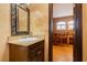 Elegant powder room with a decorative mirror and sink, adjacent to the game room at 7625 Coley Ave, Las Vegas, NV 89117