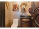 Elegant powder room featuring textured walls, stylish mirror, and vessel sink at 7625 Coley Ave, Las Vegas, NV 89117