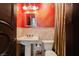 Chic powder room featuring stone accents, decorative mirror, and elegant fixtures at 7625 Coley Ave, Las Vegas, NV 89117