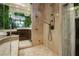 Modern shower with marble walls, updated fixtures, and a glass door, complemented by a garden wall at 7625 Coley Ave, Las Vegas, NV 89117