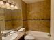 Bathroom featuring a tub, shower, tiled walls with decorative mosaic tile, and a granite countertop sink at 7912 Foxwood Pl # 104, Las Vegas, NV 89145