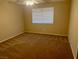 Cozy bedroom with neutral walls, carpet, a ceiling fan, and bright natural light provided by the window at 7912 Foxwood Pl # 104, Las Vegas, NV 89145
