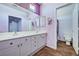 Bathroom featuring double sinks, modern fixtures and a walk-in shower with purple shower curtain at 7920 Aviano Pines Ave, Las Vegas, NV 89129