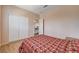 Bedroom showcasing a double closet, wood look floors, with access to the second-floor landing at 7920 Aviano Pines Ave, Las Vegas, NV 89129