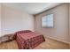 Cozy bedroom with a colorful quilt, wood-look floors, and ample natural light at 7920 Aviano Pines Ave, Las Vegas, NV 89129