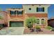 Charming two-story home showcasing a green garage door, shutters and lush landscaping at 7920 Aviano Pines Ave, Las Vegas, NV 89129