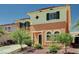 Charming two-story home showcasing green shutters and lush landscaping at 7920 Aviano Pines Ave, Las Vegas, NV 89129