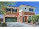 Charming two-story home showcasing a green garage door, shutters and lush landscaping at 7920 Aviano Pines Ave, Las Vegas, NV 89129