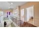 Upstairs hallway featuring hardwood floors, access to bedrooms, and an open view to the lower level at 7920 Aviano Pines Ave, Las Vegas, NV 89129