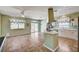 A light and airy kitchen with ceiling fan, white cabinets, and tile flooring at 7920 Aviano Pines Ave, Las Vegas, NV 89129