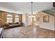 Bright living room features arch windows, tile floors, and chandelier at 7920 Aviano Pines Ave, Las Vegas, NV 89129