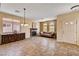 Bright living room with fireplace, tile floors, view, and chandelier at 7920 Aviano Pines Ave, Las Vegas, NV 89129
